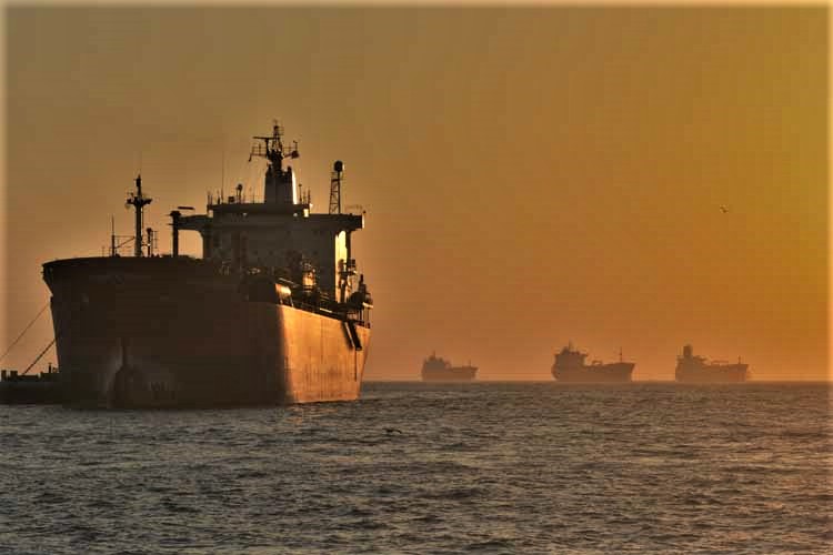 freighter in water at sunrise